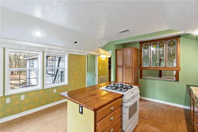 a kitchen with stainless steel appliances granite countertop a stove refrigerator and a window