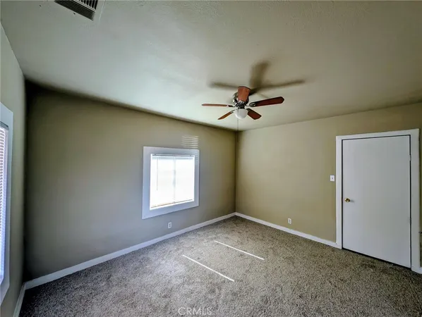 a view of a livingroom with a ceiling fan and window