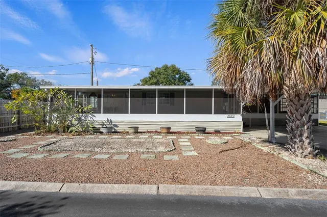 a front view of a house with a garden and patio