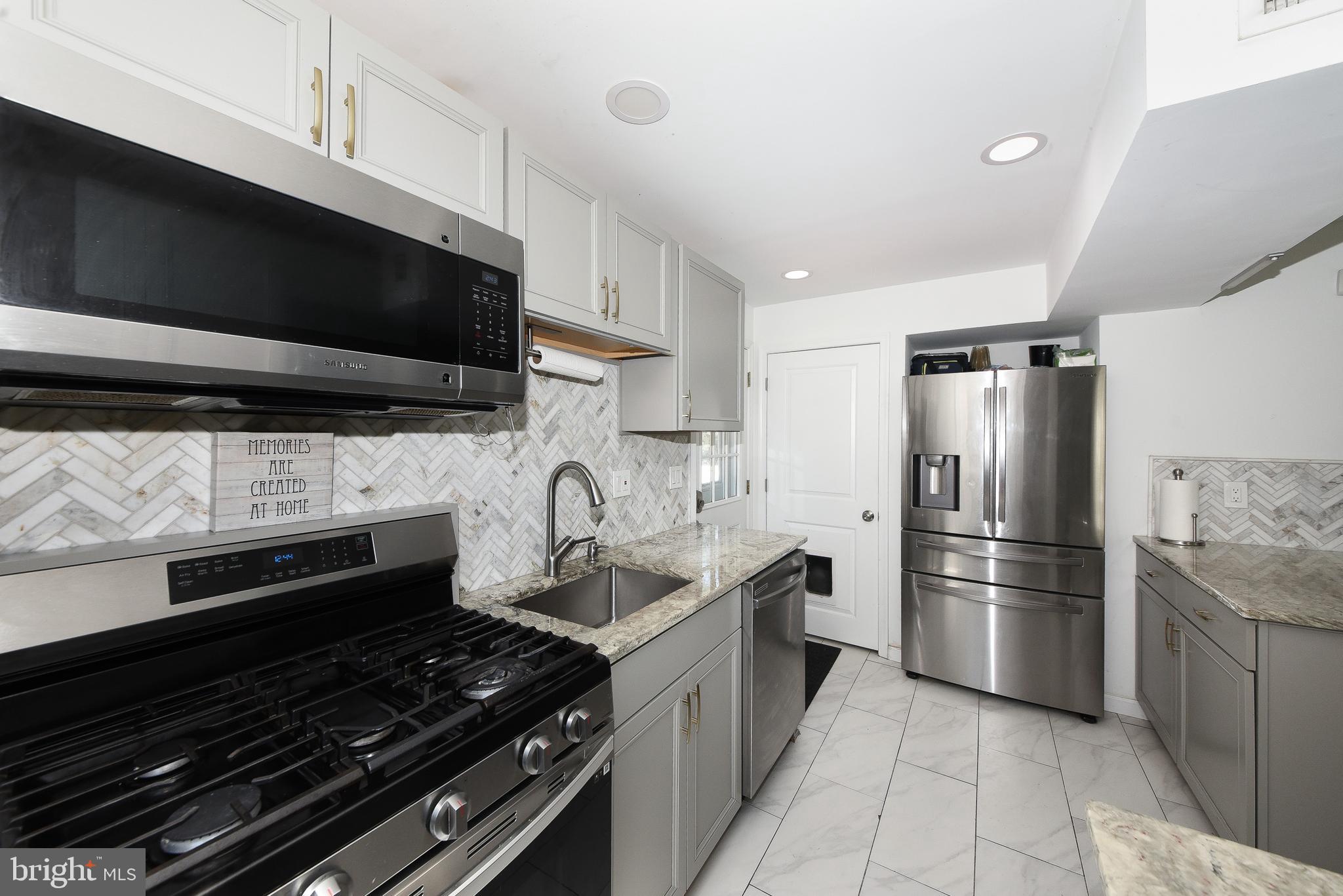 1014 North York Road Willow Grove, PA 19090 - Photo 11 of 33 a kitchen with stainless steel appliances granite countertop a stove and a refrigerator
