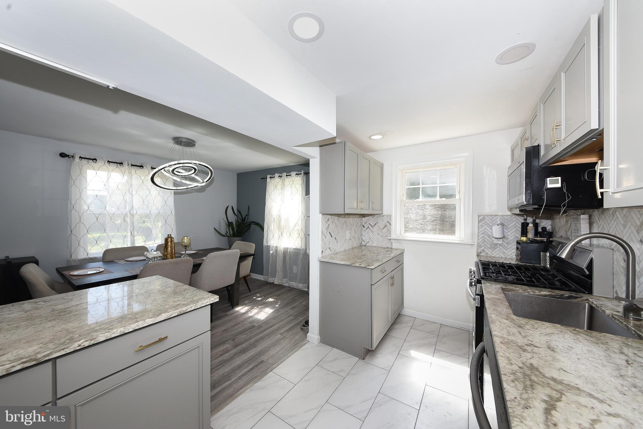 1014 North York Road Willow Grove, PA 19090 - Photo 10 of 33 a kitchen with stainless steel appliances granite countertop a sink stove and cabinets