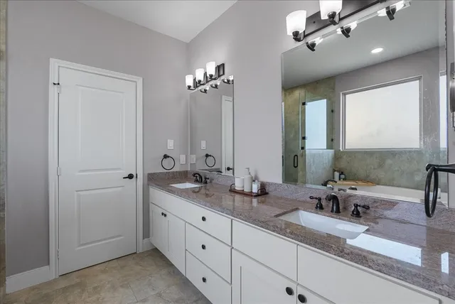 a bathroom with double sink and a mirror