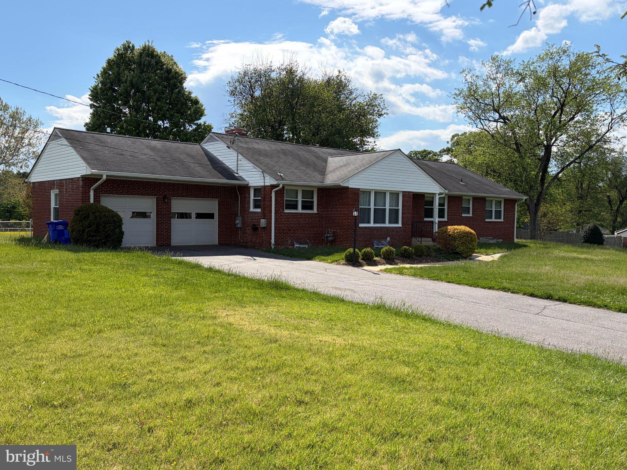 Charming brick home with lush lawn.