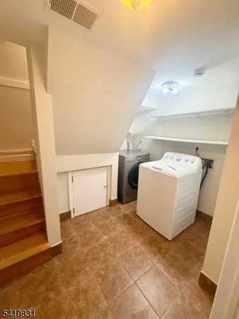 a view of a room with door and stairs