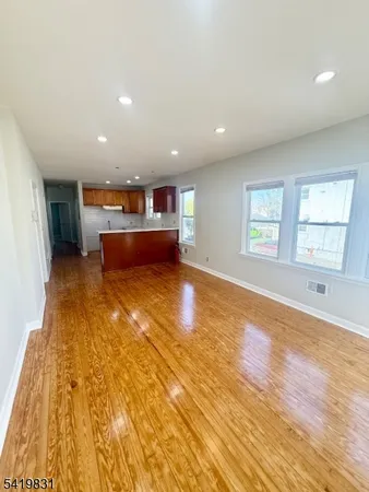 a view of kitchen and hall with wooden floor