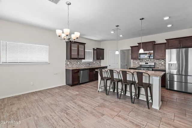 a kitchen with a stove sink and cabinets