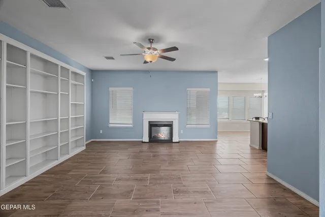 a view of kitchen with refrigerator stove and wooden floor