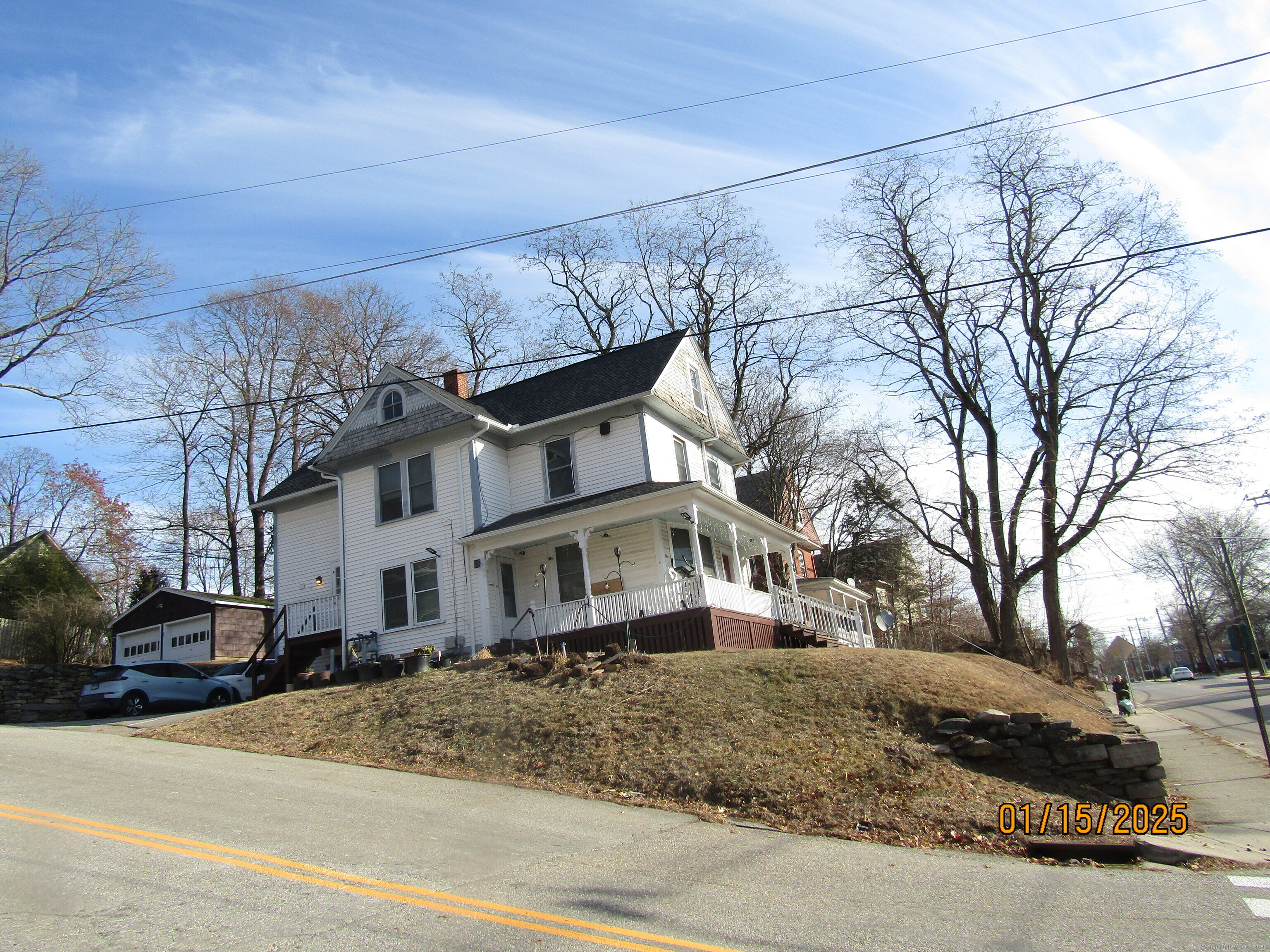 319 Valley Street, Unit 2 Windham, CT 06226 - Photo 1 of 1 a view of a white house with a snow on the road