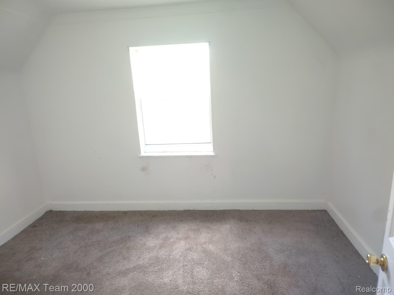 8860 Appoline Street Detroit, MI 48228 - Photo 44 of 45 Room featuring a single window, white walls, and gray carpet flooring
