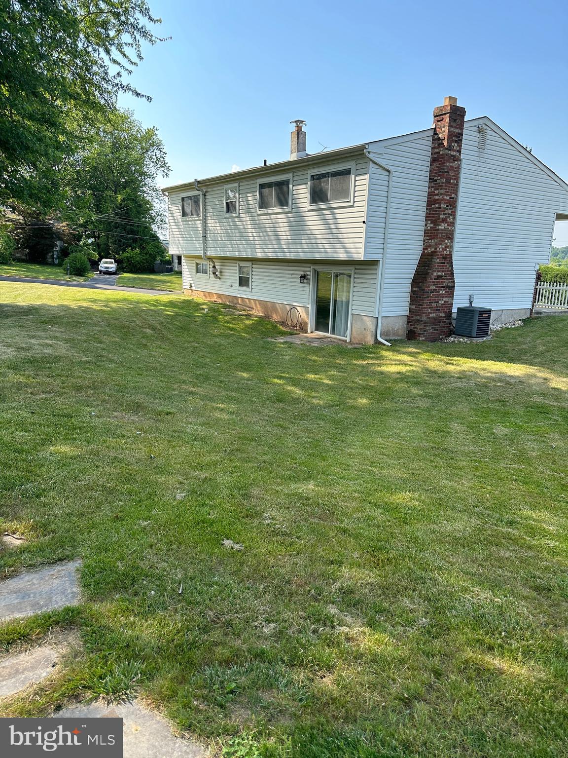 133 Inland Road Warminster, PA 18974 - Photo 2 of 10 a view of a big house with a big yard plants and large trees