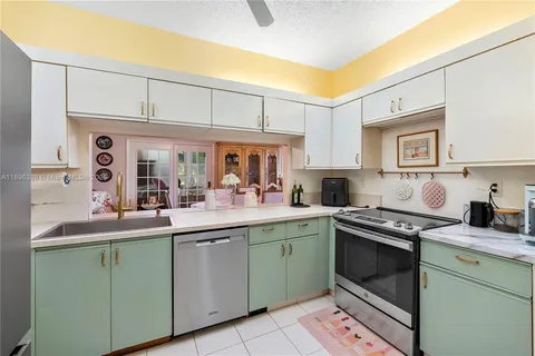 a kitchen with stainless steel appliances granite countertop a sink and cabinets