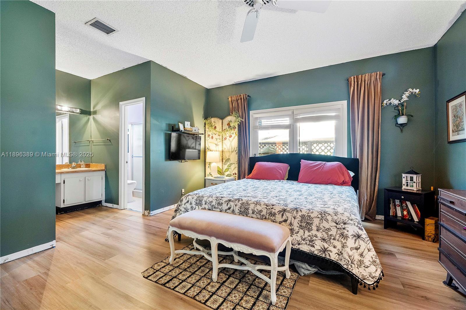 4764 South Hemingway Circle Margate, FL 33063 - Photo 13 of 30 a bedroom with a bed and wooden floor