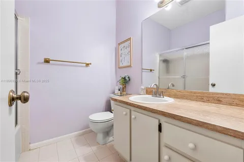 a bathroom with a granite countertop sink a toilet and a mirror