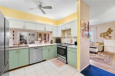 a kitchen with cabinets a sink and appliances