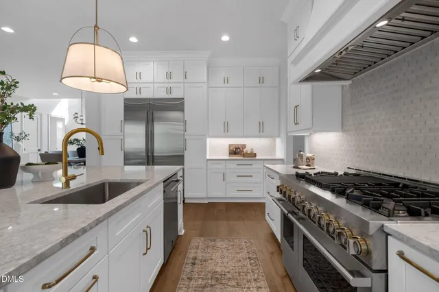 a kitchen with a sink cabinets and appliances