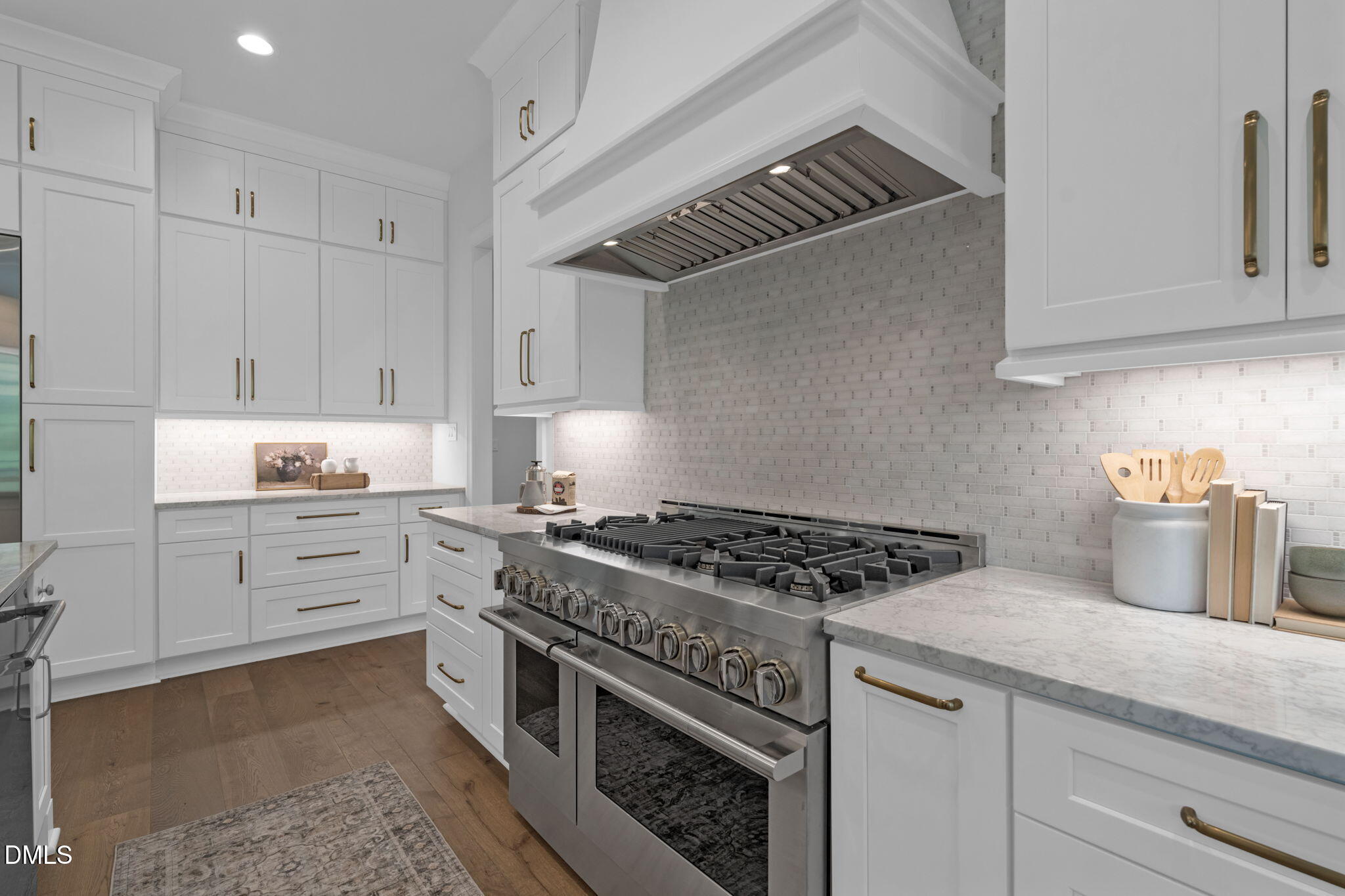 1609 Legacy Ridge Lane Wake Forest, NC 27587 - Photo 24 of 71 a kitchen with granite countertop a stove and white cabinets