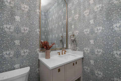a view of a big room with wooden floor and chandelier