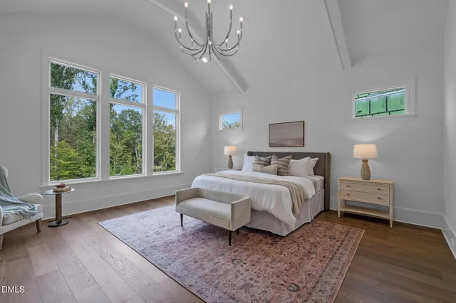 an empty room with windows and a ceiling fan