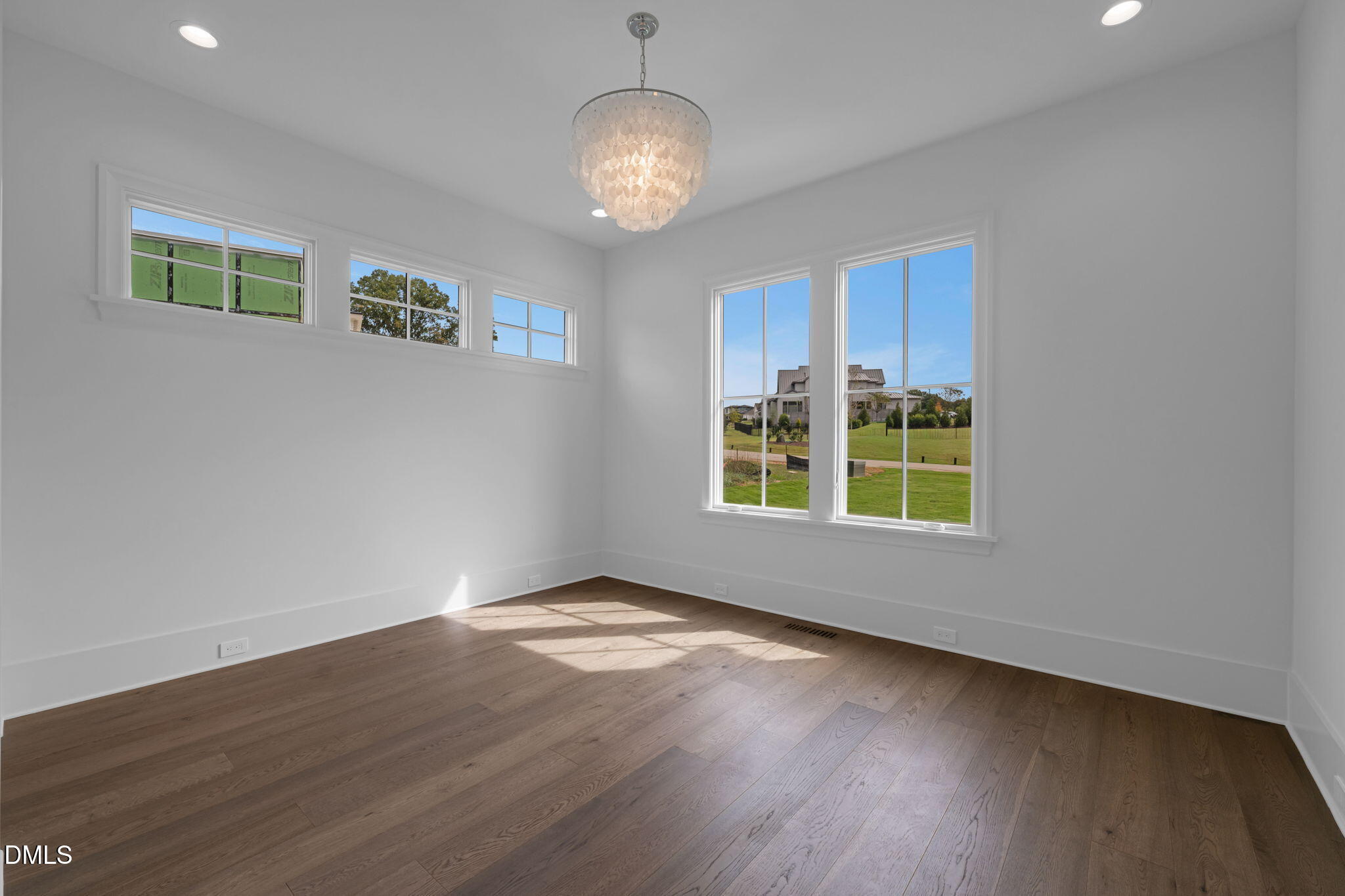 1609 Legacy Ridge Lane Wake Forest, NC 27587 - Photo 42 of 71 a view of a livingroom with wooden floor and a large window