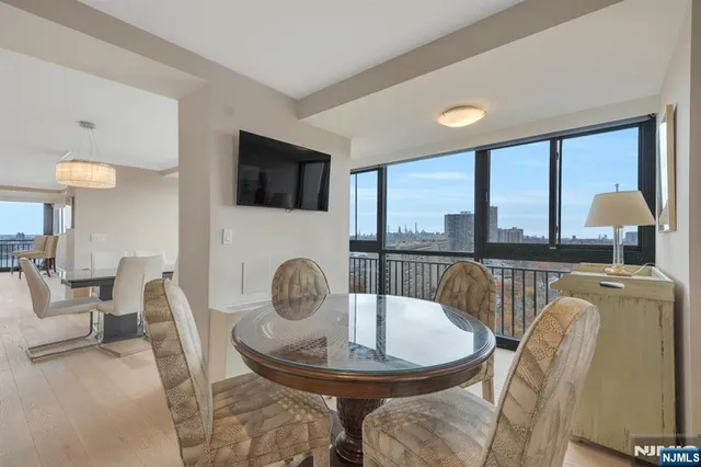 a dining room with furniture a fireplace and a large window