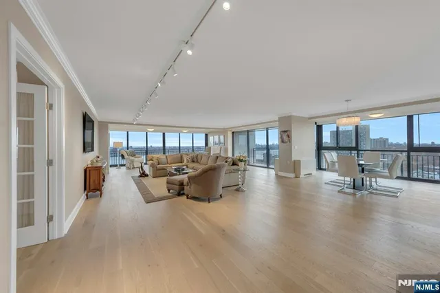 a living room with furniture and a table with wooden floor