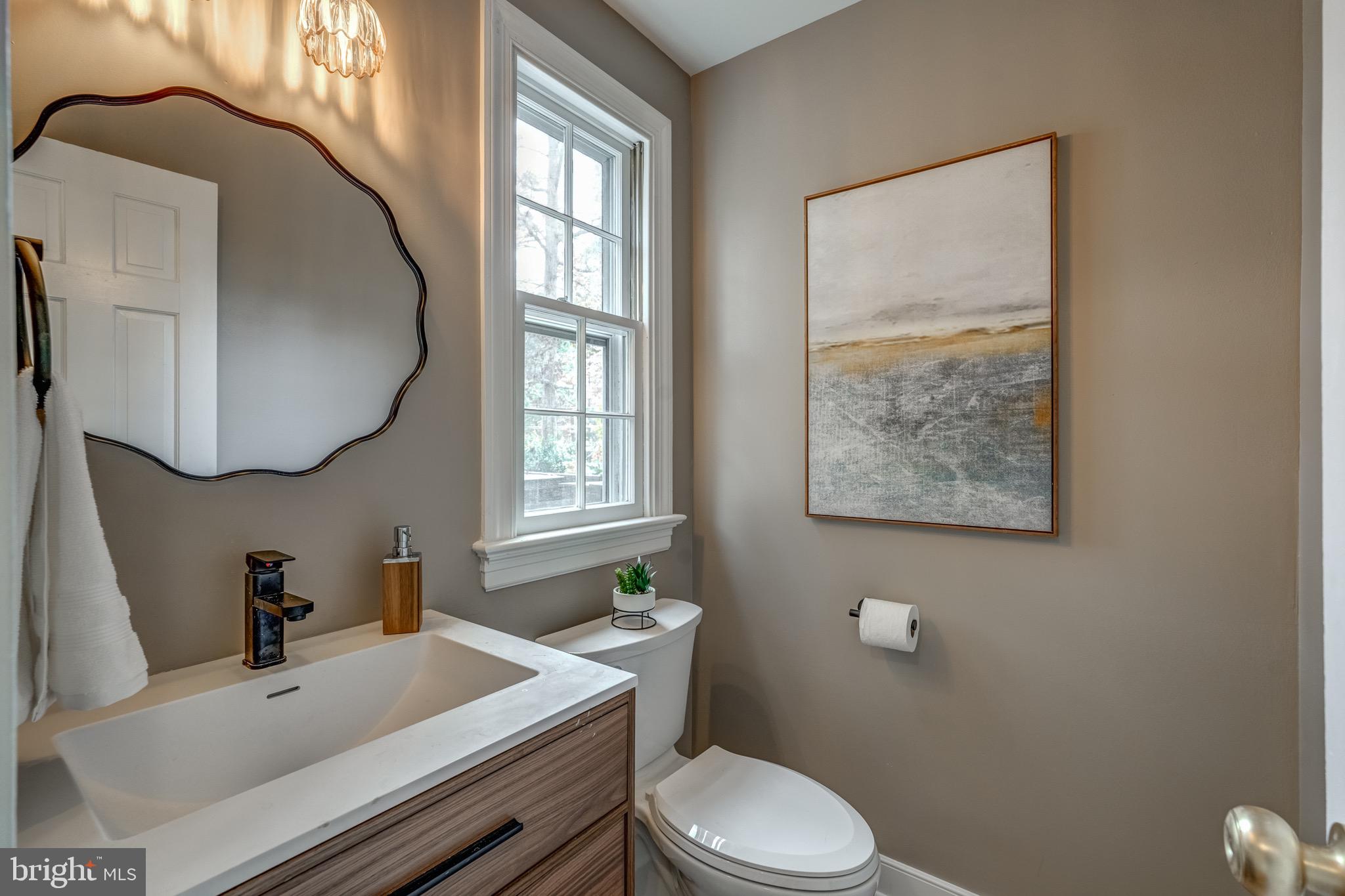 1771 Robindale Road North Chesterfield, VA 23235 - Photo 17 of 67 a bathroom with a sink toilet and mirror