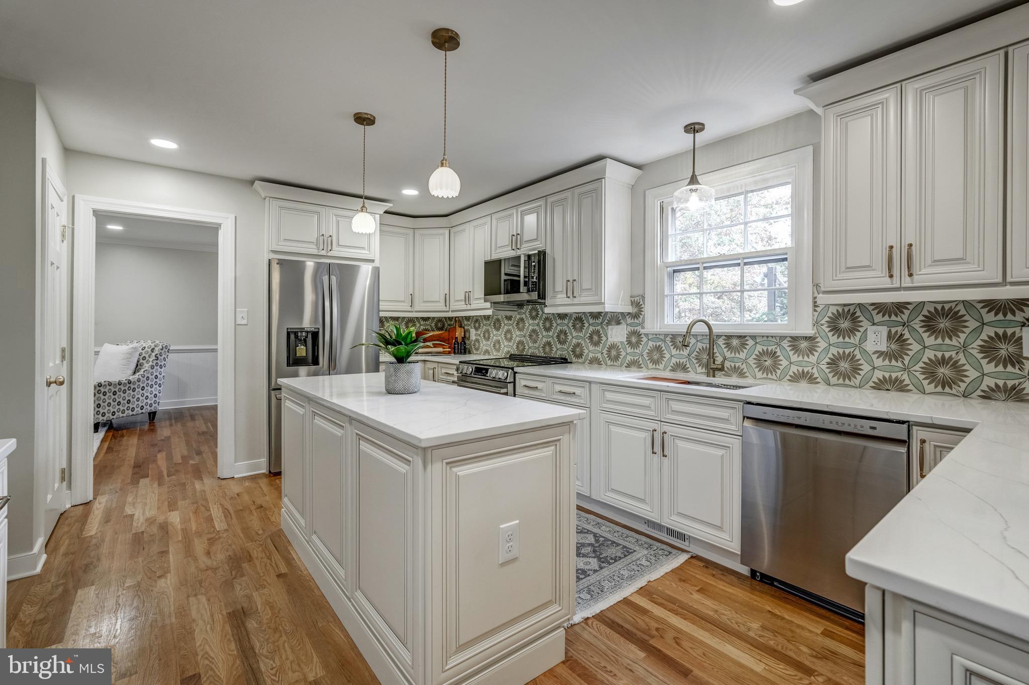 1771 Robindale Road North Chesterfield, VA 23235 - Photo 26 of 67 a kitchen with kitchen island granite countertop a sink appliances cabinets and a counter top space