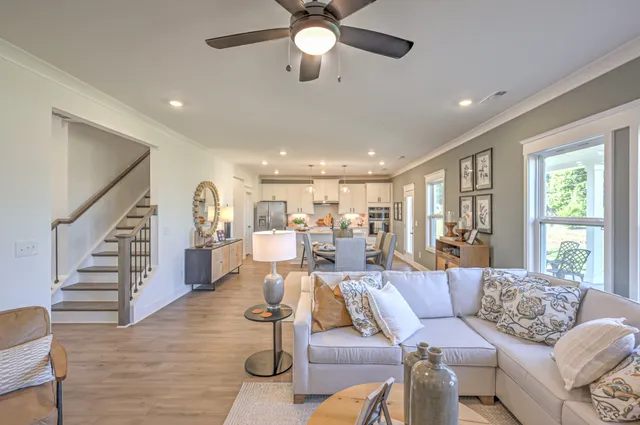 a living room with furniture and wooden floor