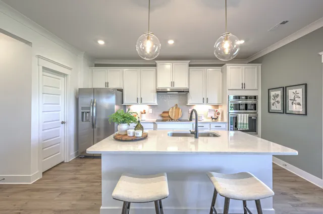 a view of kitchen with sink dining table and chairs