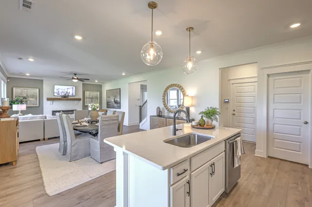 a kitchen with counter space appliances and living room
