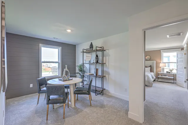 a view of a livingroom with furniture and a window