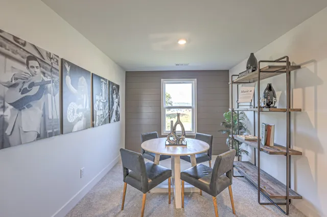 a view of a dining room with furniture and a window