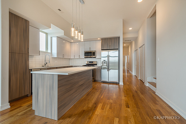2835 West Division Street, Unit 2E Chicago, IL 60622 - Photo 15 of 33 a kitchen with wooden floors appliances and cabinets