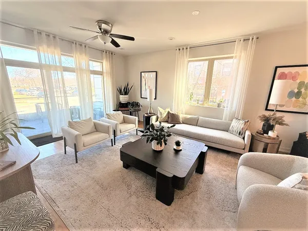 a living room with furniture and a large window