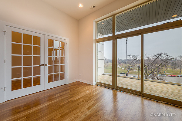 2835 West Division Street, Unit 2E Chicago, IL 60622 - Photo 10 of 33 a view of empty room with wooden floor and floor to ceiling window