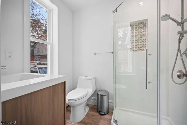 a white toilet sitting next to a bathroom sink
