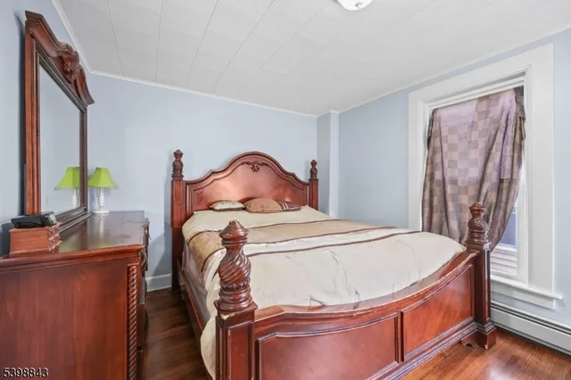 a bed sitting in a bedroom next to a window