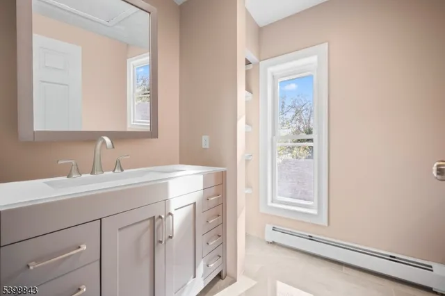 a bathroom with a sink a vanity and a mirror