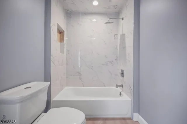 a bathroom with a toilet and a bathtub