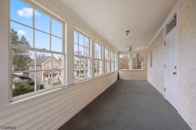 a view of an entryway with wooden floor