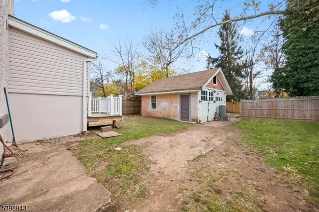 a view of a house with a yard and garage