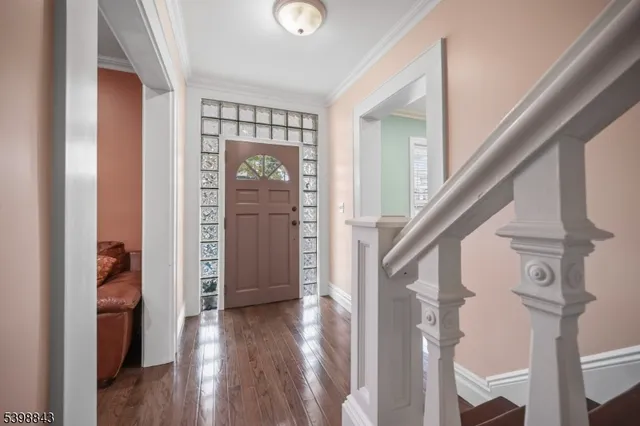 a view of entryway with wooden floor and stairs