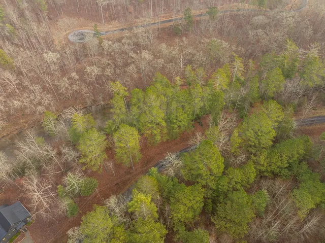 an outdoor view of house with swimming pool and furniture