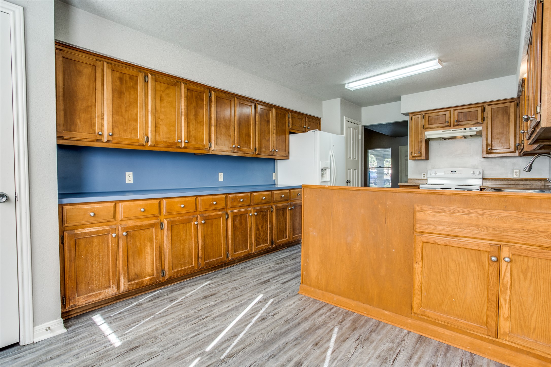 106 Verna Spur, Unit B Georgetown, TX 78628 - Photo 12 of 25 Functional kitchen with ample cabinetry and easy-to-maintain flooring.