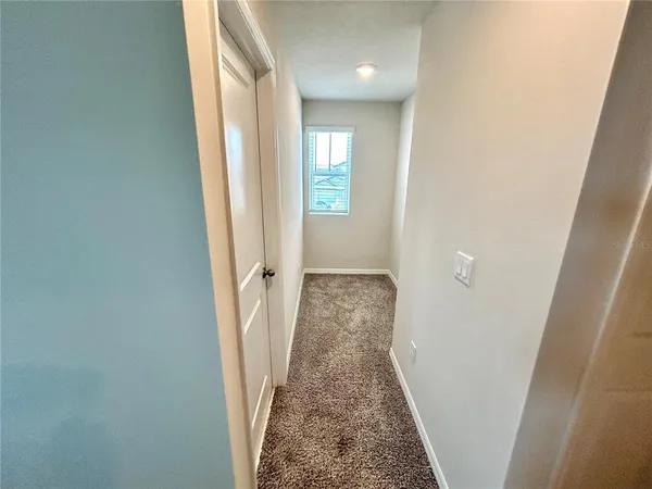 a view of a hallway with a white walls