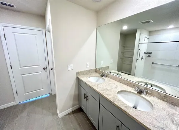 a bathroom with a granite countertop sink and a mirror
