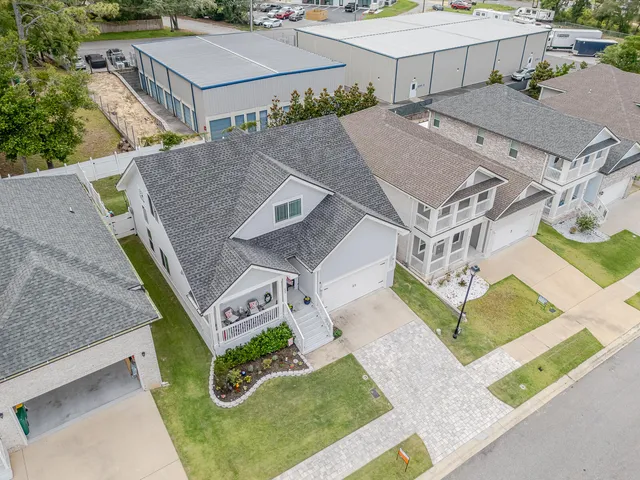 a living room with furniture potted plant and a large window