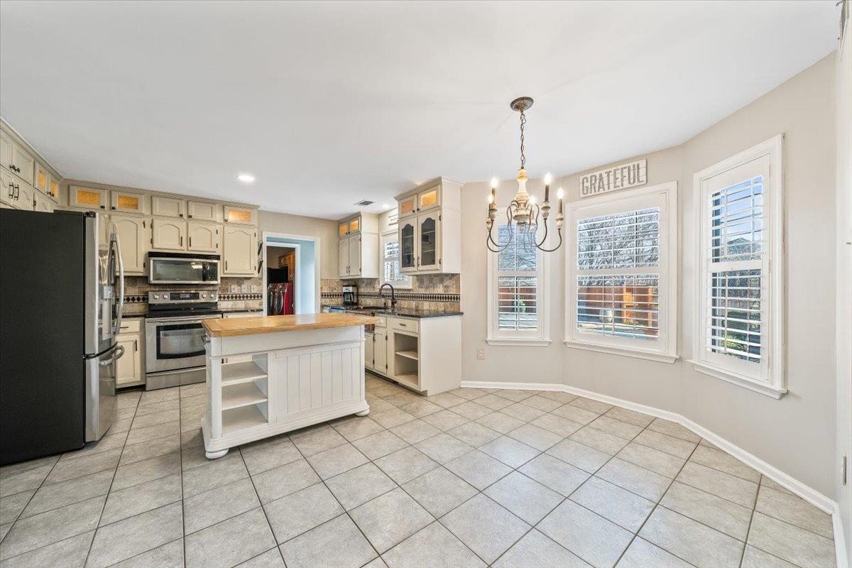 3204 Falling Star Cove Bartlett, TN 38134 - Photo 11 of 36 a kitchen with granite countertop cabinets and steel stainless steel appliances