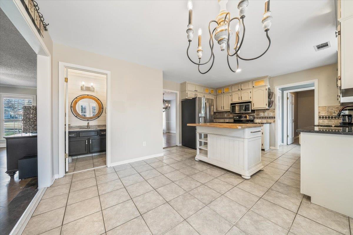 3204 Falling Star Cove Bartlett, TN 38134 - Photo 12 of 36 a kitchen with granite countertop a white stove top oven and cabinets