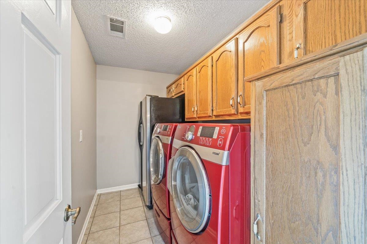 3204 Falling Star Cove Bartlett, TN 38134 - Photo 16 of 36 a utility room with dryer and washer